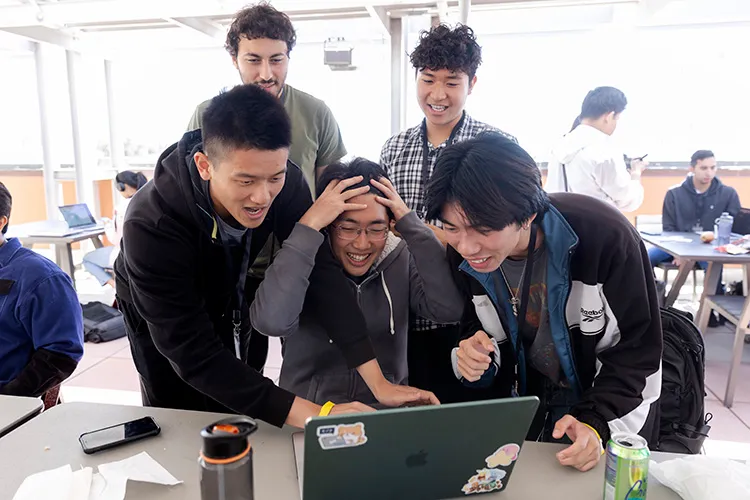 A hackathon team reacting to their build coming together
