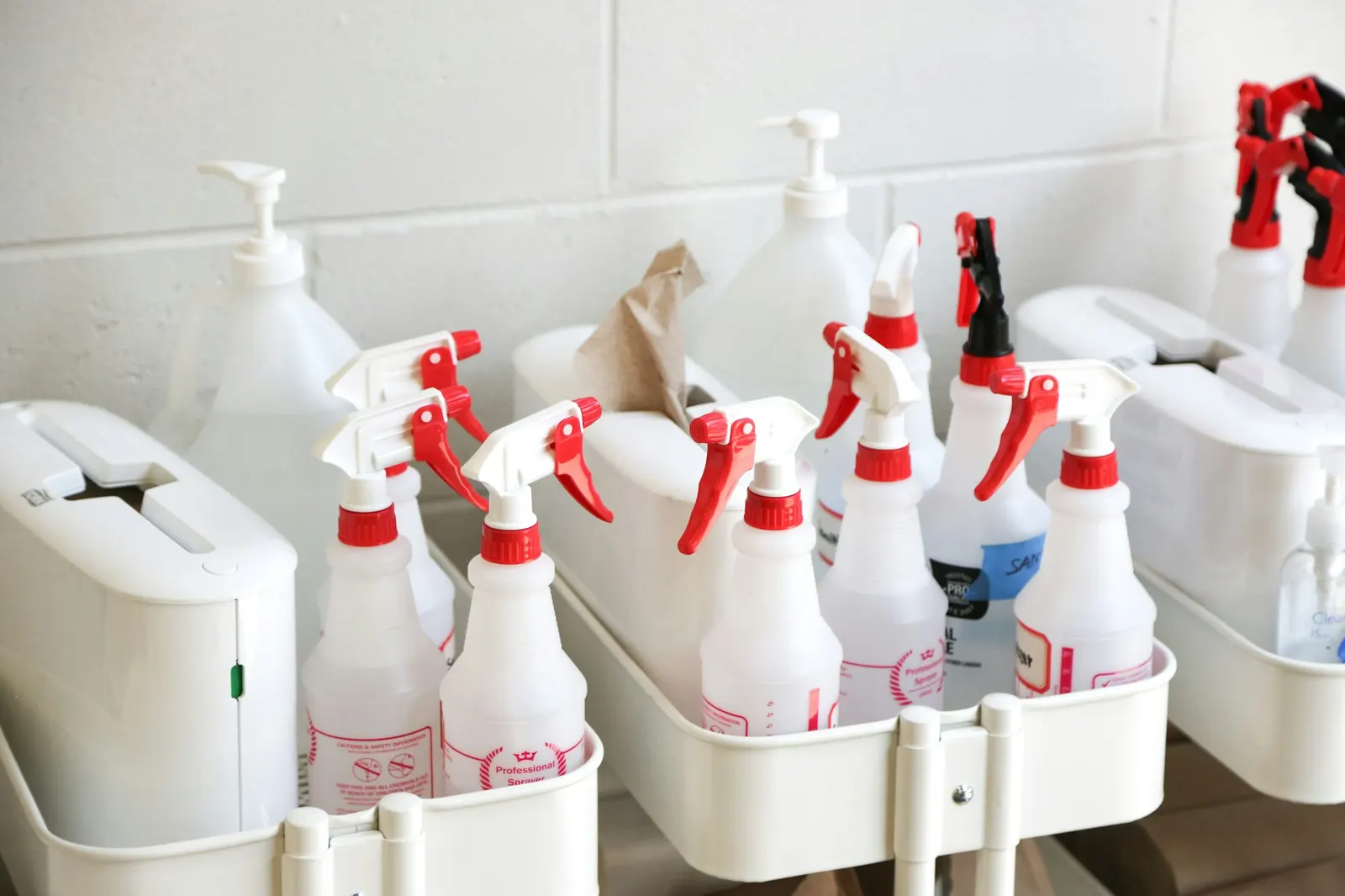 White cleaning caddy packed with spray bottles and cleaning products
