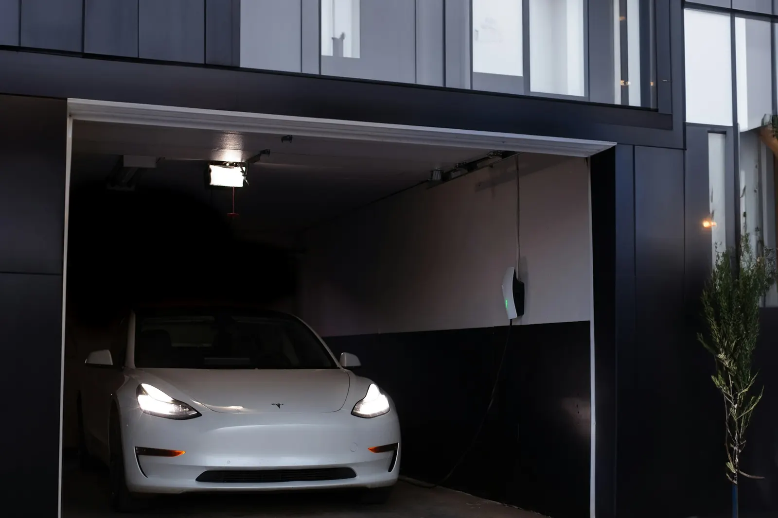 Clean modern garage with a single white car and clear open floor
