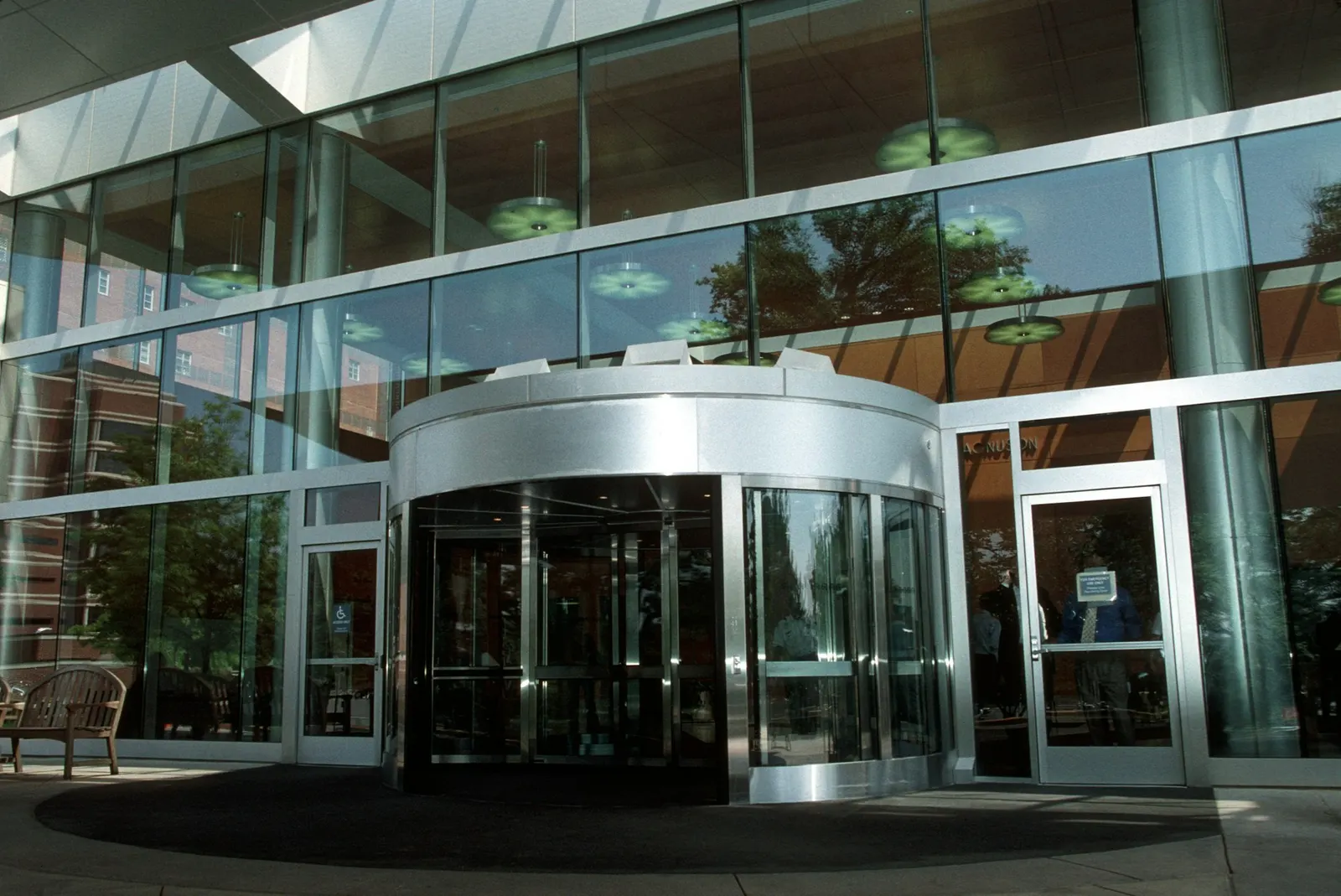 Glass entrance and revolving door of a modern medical clinic building