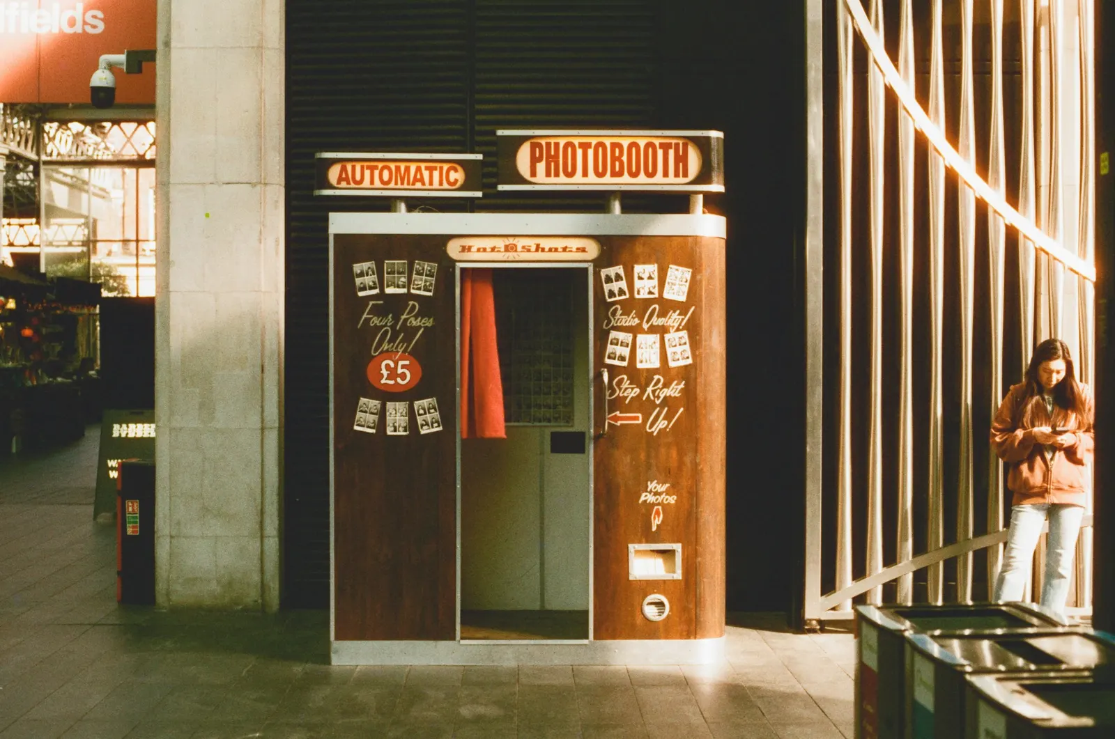 Brightly lit automatic photo booth set up inside an event venue