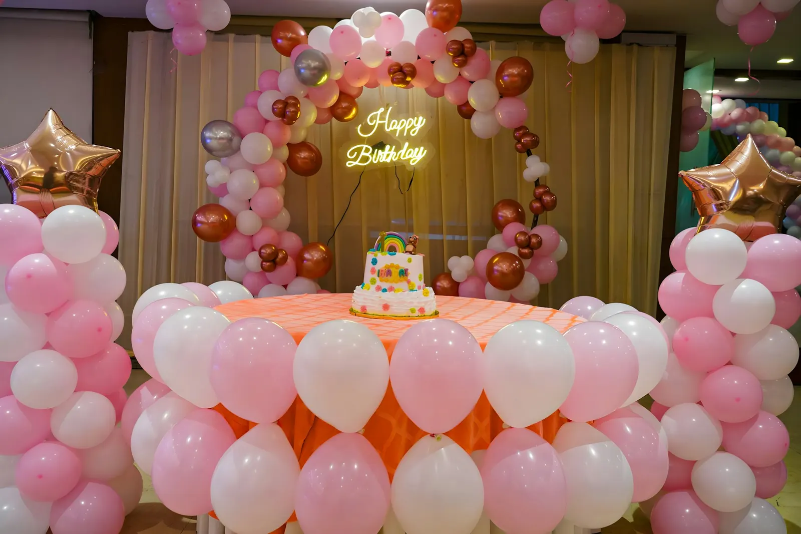 Festive party backdrop decorated with clusters of colorful balloons