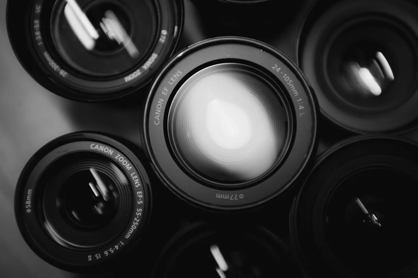 Set of six camera zoom lenses lined up on a table