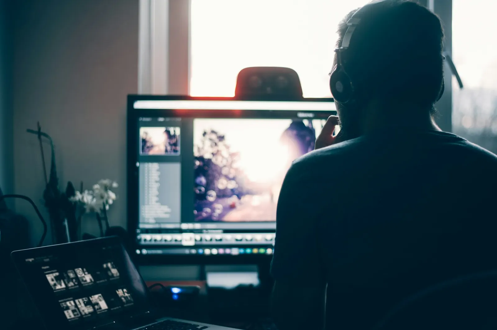 Photographer editing images on a large desktop monitor at a workstation