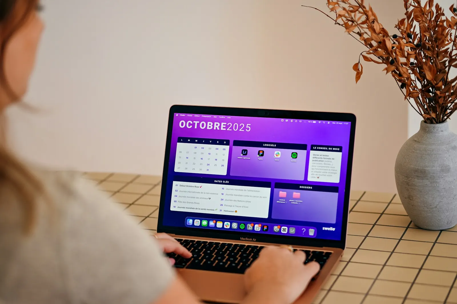 Person managing a monthly calendar and scheduled tasks on a laptop screen